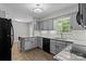 Updated kitchen boasts light gray cabinets, stainless steel appliances, and a stylish design at 4232 Saint Audrey Pl, Charlotte, NC 28269
