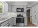 Updated kitchen featuring light gray cabinets, stainless oven, and subway tile backsplash at 4232 Saint Audrey Pl, Charlotte, NC 28269