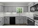 Updated kitchen features light gray cabinets, stainless steel appliances and bright subway tile backsplash at 4232 Saint Audrey Pl, Charlotte, NC 28269