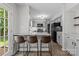 Updated kitchen with light gray cabinetry, granite counters, stainless appliances, and breakfast bar seating at 4232 Saint Audrey Pl, Charlotte, NC 28269
