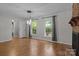 Bright living room with hardwood floors, a brick fireplace, and pendant lighting at 4232 Saint Audrey Pl, Charlotte, NC 28269