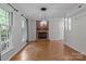 Spacious living room with hardwood floors, a brick fireplace, and ample natural light at 4232 Saint Audrey Pl, Charlotte, NC 28269