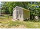 Exterior shot of tan storage shed with ramp access and white trim at 4232 Saint Audrey Pl, Charlotte, NC 28269