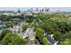 Aerial view of a neighborhood with green canopy and skyline in the distance at 430 Queens Rd # 332, Charlotte, NC 28207
