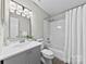 Bright bathroom featuring a shower-tub, neutral tile, and a gray vanity at 430 Queens Rd # 332, Charlotte, NC 28207