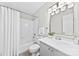 Bright bathroom featuring a shower-tub, neutral tile, and a gray vanity at 430 Queens Rd # 332, Charlotte, NC 28207