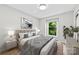Serene bedroom boasts soft lighting, a decorative headboard, and a large window that frames a scenic outdoor view at 430 Queens Rd # 332, Charlotte, NC 28207