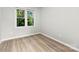 Well-lit bedroom featuring light wood flooring and large windows at 430 Queens Rd # 332, Charlotte, NC 28207