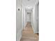 Hallway with wood-look flooring and neutral paint with white trim provides a calming transition between rooms at 430 Queens Rd # 332, Charlotte, NC 28207