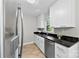 Modern kitchen with stainless steel dishwasher, granite countertops, white cabinets and wood-look tile flooring at 430 Queens Rd # 332, Charlotte, NC 28207