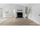 Inviting living room with a cozy fireplace, neutral paint, and light wood flooring at 430 Queens Rd # 332, Charlotte, NC 28207