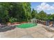 Community pool surrounded by green trees and lounge chairs at 430 Queens Rd # 332, Charlotte, NC 28207