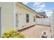 This outdoor space features a stone patio, white fence, and vinyl siding at 4504 Sages Ave, Indian Trail, NC 28079