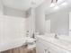 This bathroom features a shower-tub combo, single sink vanity, and wood-look flooring at 4504 Sages Ave, Indian Trail, NC 28079