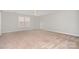 Spacious bedroom with neutral walls, carpet, a ceiling fan, and a window with bright natural light at 4504 Sages Ave, Indian Trail, NC 28079