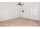 Spacious bedroom with neutral walls, carpet flooring, large windows, and a ceiling fan at 4504 Sages Ave, Indian Trail, NC 28079