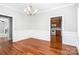 Formal dining room featuring hardwood floors, decorative molding, and stylish light fixtures at 4504 Sages Ave, Indian Trail, NC 28079