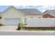 Exterior view shows a yellow home, white fence, and an attached garage at 4504 Sages Ave, Indian Trail, NC 28079