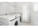 Functional laundry room with white washer and dryer, wire shelving, and a white door at 4504 Sages Ave, Indian Trail, NC 28079
