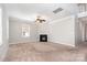 Open living room with a fireplace, neutral walls, carpet flooring, and a ceiling fan at 4504 Sages Ave, Indian Trail, NC 28079