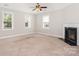 Bright living room with a fireplace, neutral walls, carpet flooring, and abundant natural light at 4504 Sages Ave, Indian Trail, NC 28079