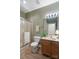 Bathroom with wood floors, standard toilet, vanity with a granite top and shower with glass door at 608 Camrose Ne Cir, Concord, NC 28025