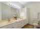 Bathroom featuring a white double sink vanity, large mirror and white walls at 608 Camrose Ne Cir, Concord, NC 28025