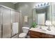 Bathroom with glass enclosed shower, matching hardware, and warm olive paint at 608 Camrose Ne Cir, Concord, NC 28025