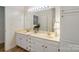 Bathroom featuring a white double sink vanity, large mirror and white walls at 608 Camrose Ne Cir, Concord, NC 28025