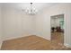 Bright dining room featuring modern lighting fixture, hardwood floors and neutral paint at 608 Camrose Ne Cir, Concord, NC 28025