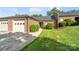 Charming single-story brick home featuring a well-maintained lawn, landscaping, and two-car garage at 608 Camrose Ne Cir, Concord, NC 28025