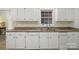 Kitchen featuring white cabinets, laminated countertops, and stainless steel sink at 608 Camrose Ne Cir, Concord, NC 28025