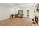 Spacious living room with fireplace, hardwood floors, and backyard views through a glass door at 608 Camrose Ne Cir, Concord, NC 28025