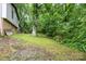 Sloped backyard with lush greenery and mature trees, offering privacy and shade at 610 N Shaver St # 14, Salisbury, NC 28144