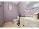 Compact bathroom featuring floral wallpaper, a toilet, and a vanity with a sink at 610 N Shaver St # 14, Salisbury, NC 28144
