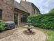 Charming backyard featuring a stone fountain, lush greenery, and a grilling station at 6128 Fletcher Cir, Charlotte, NC 28226