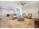 Spacious bonus room featuring hardwood floors, comfortable seating, and ample lighting at 6128 Fletcher Cir, Charlotte, NC 28226