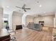 Spacious bonus room featuring hardwood floors, comfortable seating, and ample lighting at 6128 Fletcher Cir, Charlotte, NC 28226