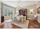 Bright dining room with hardwood floors, chandelier, and large window offering lots of light at 6128 Fletcher Cir, Charlotte, NC 28226