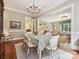Bright dining room with hardwood floors, chandelier, and direct access to the living room and kitchen at 6128 Fletcher Cir, Charlotte, NC 28226