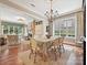 Open concept dining room with view into the living room, features a chandelier and large windows at 6128 Fletcher Cir, Charlotte, NC 28226