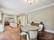 Well-lit dining area offers hardwood floors and seamless flow into the kitchen at 6128 Fletcher Cir, Charlotte, NC 28226