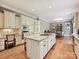 Spacious kitchen boasts large island, granite countertops, and ample cabinet space at 6128 Fletcher Cir, Charlotte, NC 28226