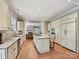 Bright kitchen with stainless steel appliances, granite counters, and center island seating at 6128 Fletcher Cir, Charlotte, NC 28226
