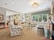 Open concept living room with fireplace, large windows overlooking backyard, and access to the kitchen at 6128 Fletcher Cir, Charlotte, NC 28226