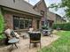 Inviting patio features ample seating and a well-manicured lawn perfect for outdoor entertaining at 6128 Fletcher Cir, Charlotte, NC 28226