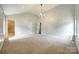 Large carpeted bedroom with modern chandelier, vaulted ceiling, and neutral paint at 752 Chipmeadow Ln, York, SC 29745