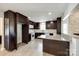 Well-lit kitchen featuring dark wood cabinets, granite countertops, and modern appliances at 752 Chipmeadow Ln, York, SC 29745
