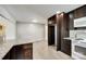Modern kitchen featuring granite countertops and dark wood cabinets, transitioning into living area at 752 Chipmeadow Ln, York, SC 29745