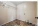 Well-lit laundry room featuring checkerboard floors and practical shelving at 752 Chipmeadow Ln, York, SC 29745
